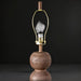 Surya Algarve AGV-002 floor lamp with a brown and gold body, painted black iron base, and white linen shade.