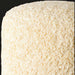 Close-up of a textured, off-white Surya Mohave cube pouf with a woven polyester surface.