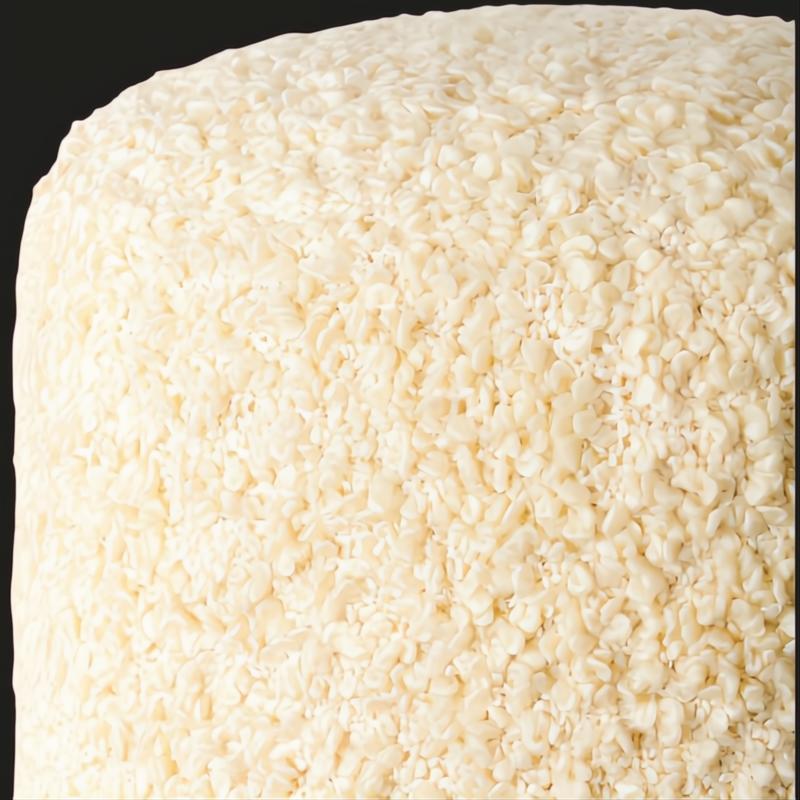 Close-up of a textured, off-white Surya Mohave cube pouf with a woven polyester surface.