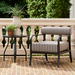 Surya Antibes accent chair with black aluminum frame and striped Sunbrella cushion on a patio.