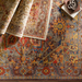 Hand-knotted Surya Cappadocia wool rug with intricate patterns in dusty sage, mauve, blue, mustard, and olive.