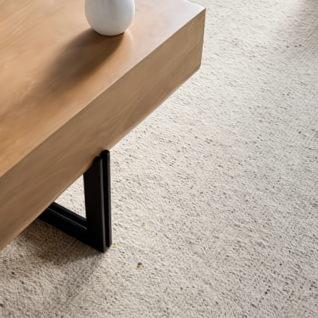 Surya Lowmax coffee table with brown mango wood top and black cast iron base on a light rug.