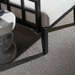 Surya Fairborn outdoor accent chair with black aluminum base, white Sunbrella cushion, and marble side table.