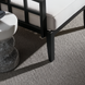 Surya Fairborn outdoor accent chair with black aluminum base, white Sunbrella cushion, and marble side table.