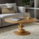 Surya Adour round coffee table with a warm brown wood top and a unique oak pedestal base.