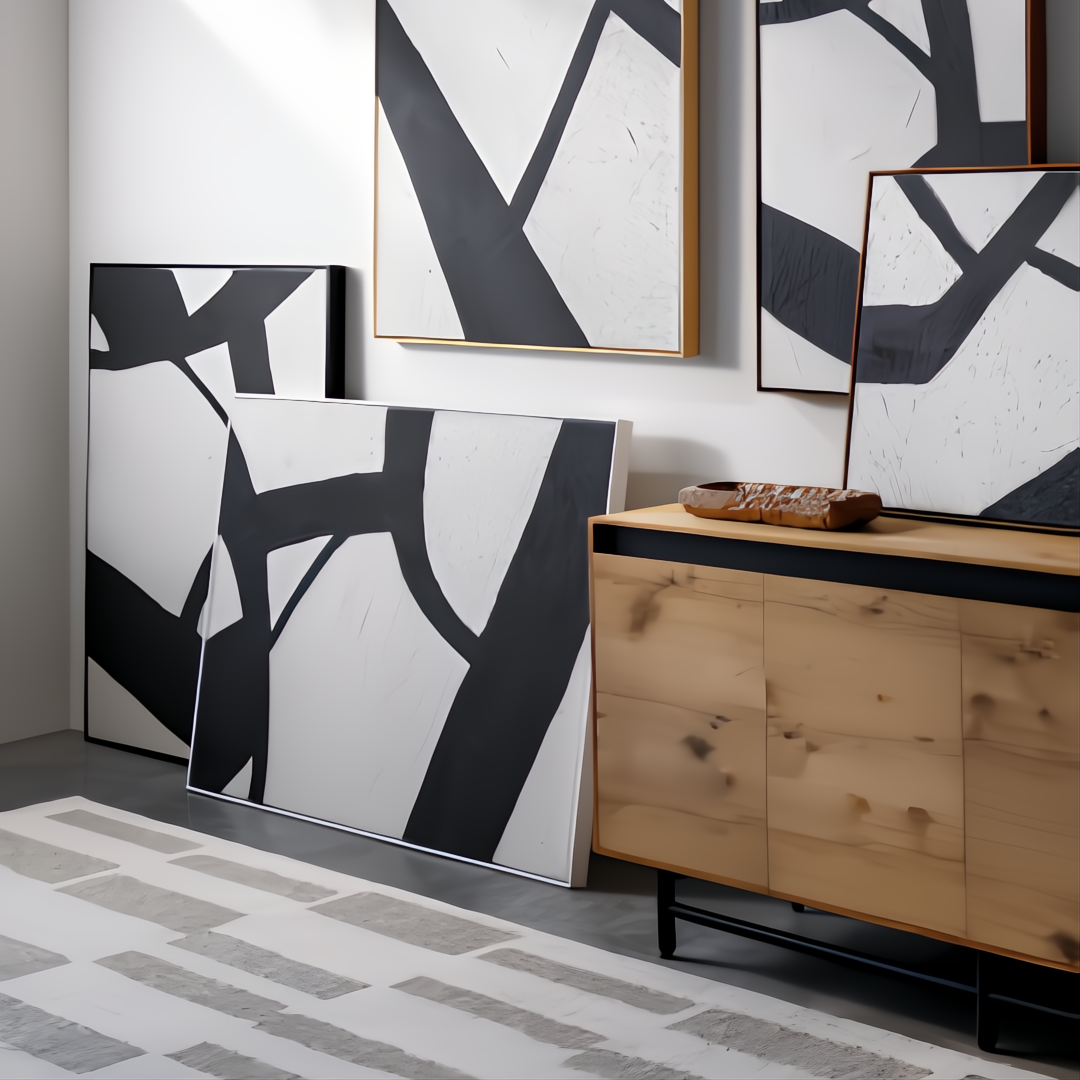 Surya Aasmaa AAM-003 abstract black and white wall art set with matte brown frames, displayed with a wooden cabinet.