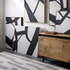 Surya Aasmaa AAM-003 abstract black and white wall art set with matte brown frames, displayed with a wooden cabinet.