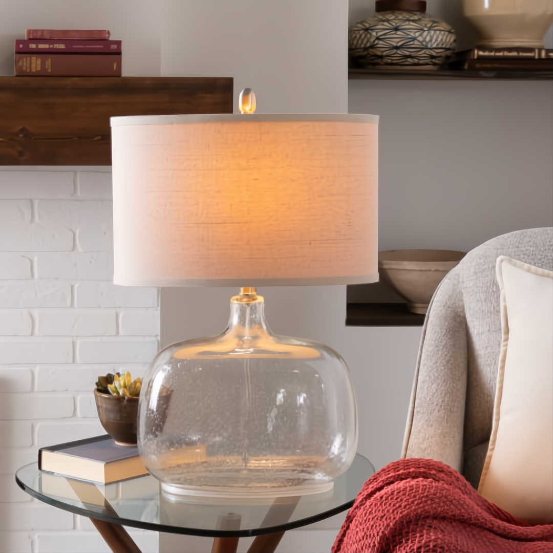 Surya Bentley accent table lamp with clear glass base, light fabric shade, and gold accents.