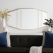 Modern elongated wall mirror with gilded metallic silver iron frame and beveled glass, above a dark sofa.