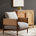 Surya Brielle accent chair with light gray polyester upholstery, camel woven sides, and a dark wood frame.