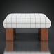 Surya Mirava Ottoman with a checkered polyester top and brown stained rubber wood base.