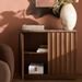 Brown Surya Skopa mid-century modern cabinet with marble top, fluted white oak doors, and open storage.
