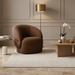 Surya Katarina accent chair in brown polyester with curved back, in a modern living room.