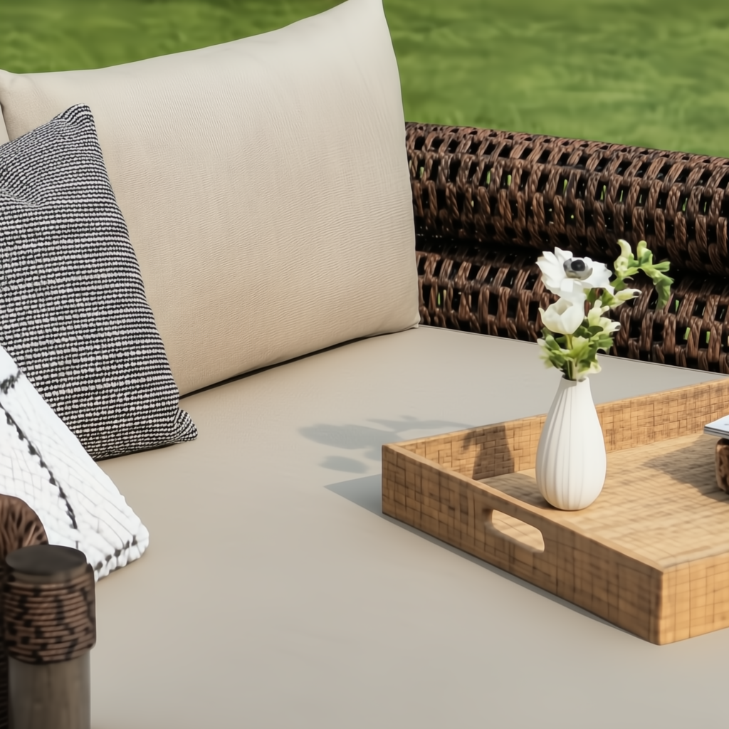 Surya Porta outdoor daybed with beige Sunbrella cushions, brown handwoven PE wicker, and a decorative tray.