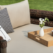 Surya Porta outdoor daybed with beige Sunbrella cushions, brown handwoven PE wicker, and a decorative tray.