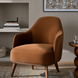 Surya Fantino accent chair with brown polyester upholstery and camel beechwood legs in a modern living space.