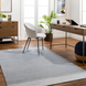 Surya Abby ABB-2300 light gray hand-woven recycled PET rug in a modern home office.