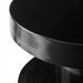Minimalist modern black iron end table with a sleek, round top and base.