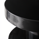 Minimalist modern black iron end table with a sleek, round top and base.