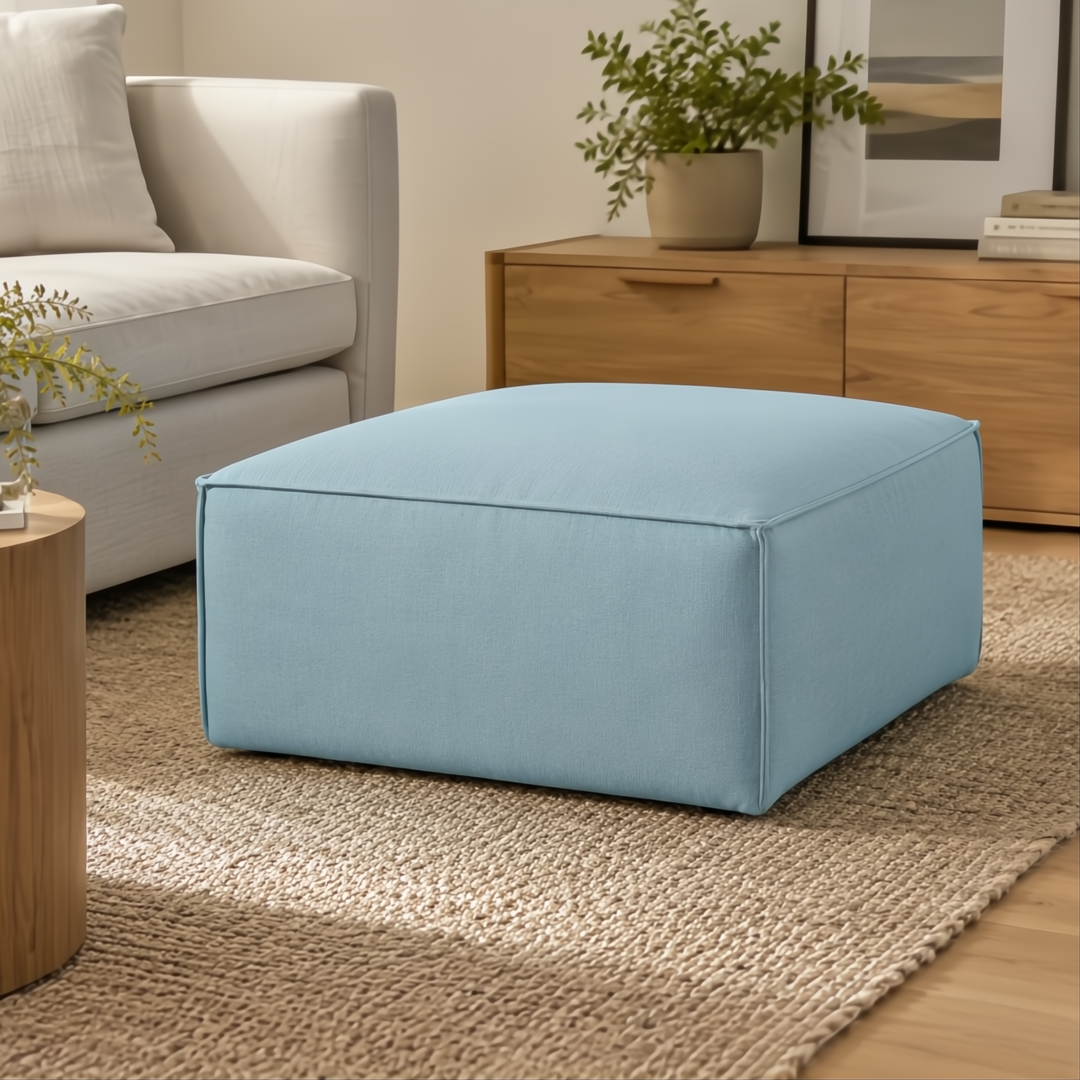 Light blue rectangular Surya Alepa ottoman with polyester cover on a natural fiber rug.