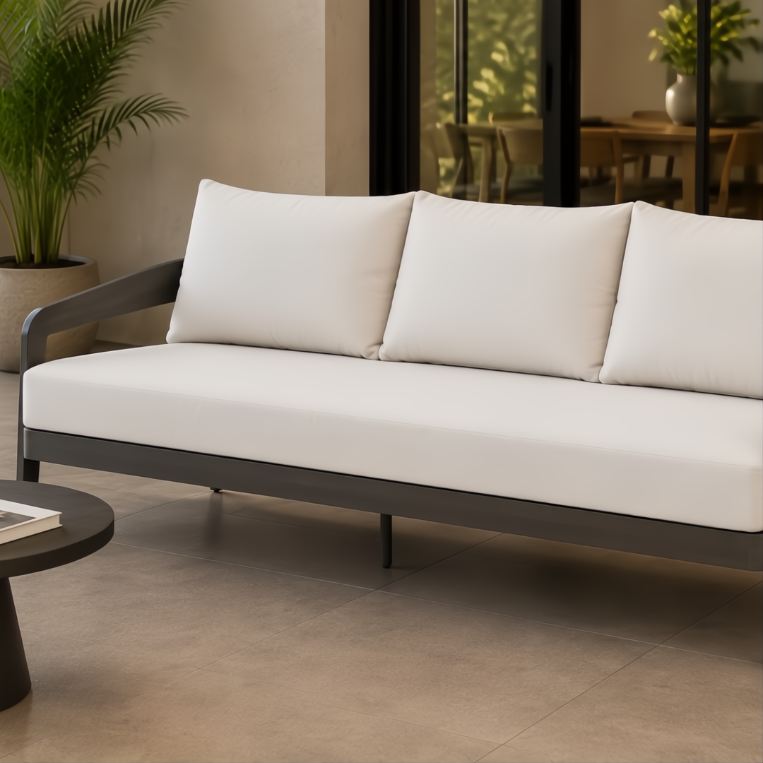 Surya Daniella outdoor sofa with light gray Sunbrella cushions and a dark gray aluminum base.