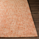 Surya Aiden AEN-1003 hand-tufted wool area rug in burnt orange and ivory, on a dark wood floor.