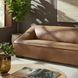 Brown leather Surya Alba sofa with clean lines in a sunlit living room.