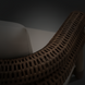 Brown wicker Surya Porta Accent Chair with light Sunbrella® cushion, suitable for outdoor use.