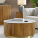Round Surya Nems coffee table with white polished marble top, reeded brown mango wood base, and gold accents.