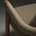 Taupe Sunbrella acrylic dining chair with a teak wood frame and woven arm detail.