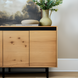 Modern Surya Molander sideboard with natural oak veneer top, black steel frame, and soft-close doors.