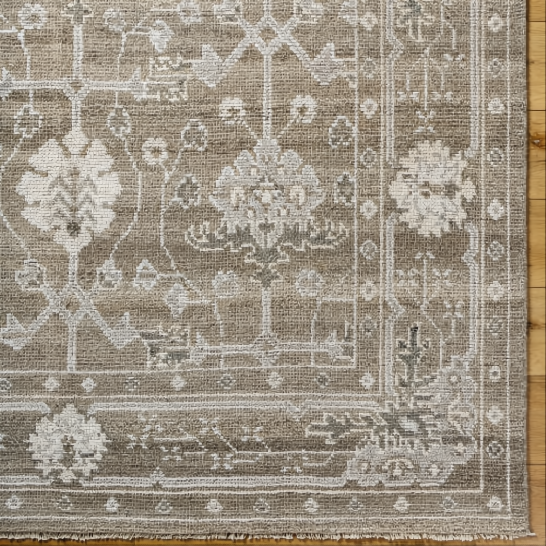 Surya Almeria hand-knotted low pile area rug in light brown, gray, and cream with fringe.