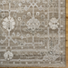 Surya Almeria hand-knotted low pile area rug in light brown, gray, and cream with fringe.