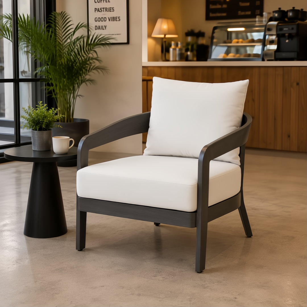 Surya Daniella outdoor accent chair with white Sunbrella cushions and a gray aluminum base.