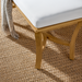 Surya Cape Town outdoor bench with wheat aluminum frame, white Sunbrella upholstery, and a woven rug.