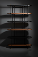 Modern Surya Pearson bookcase with dark brown wood, black tinted glass, and brass accents.