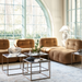Surya Capelli Accent Table Lamp with a white ceramic base and fabric shade in a living room.