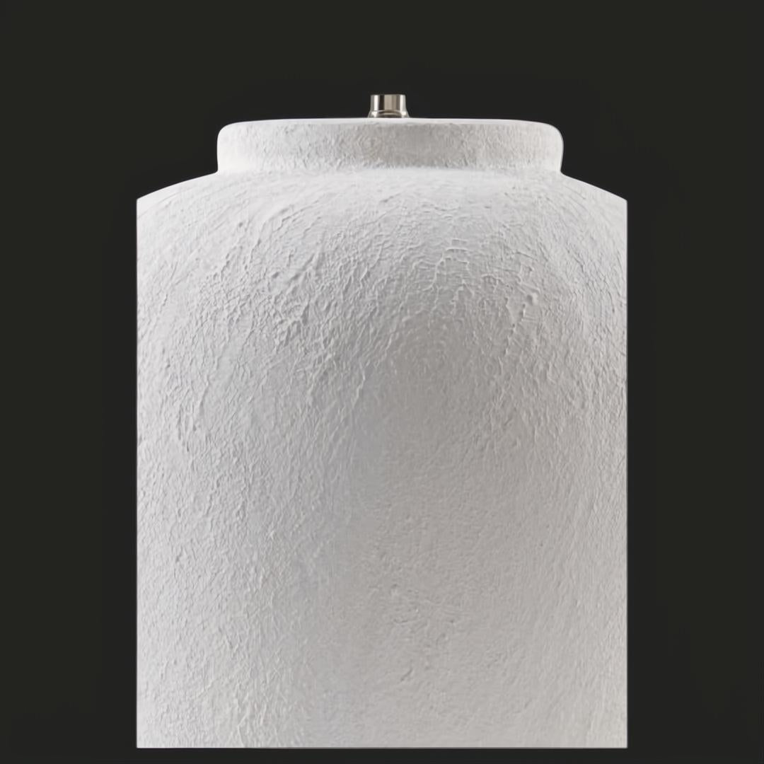 Surya Arion accent table lamp with a textured, glazed cream ceramic base.