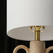 Surya Brava accent table lamp with a white fabric shade, brass hardware, and a textured beige base.
