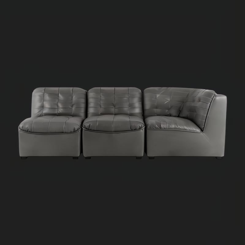 Surya Oryan RYAN-005 black 100% leather modular sofa with tufted cushions and a corner piece.