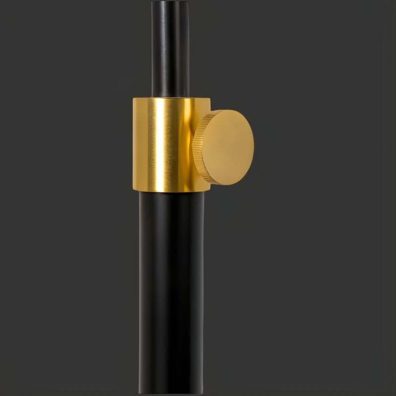 Close-up of Aberdeen accent floor lamp's black sculptural frame with a gold adjustable knob.