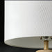 Surya Algarve accent floor lamp with a white linen shade and a light wood-toned base.