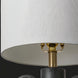 Traditional accent table lamp with black ceramic body, brass accents, and a white linen shade.