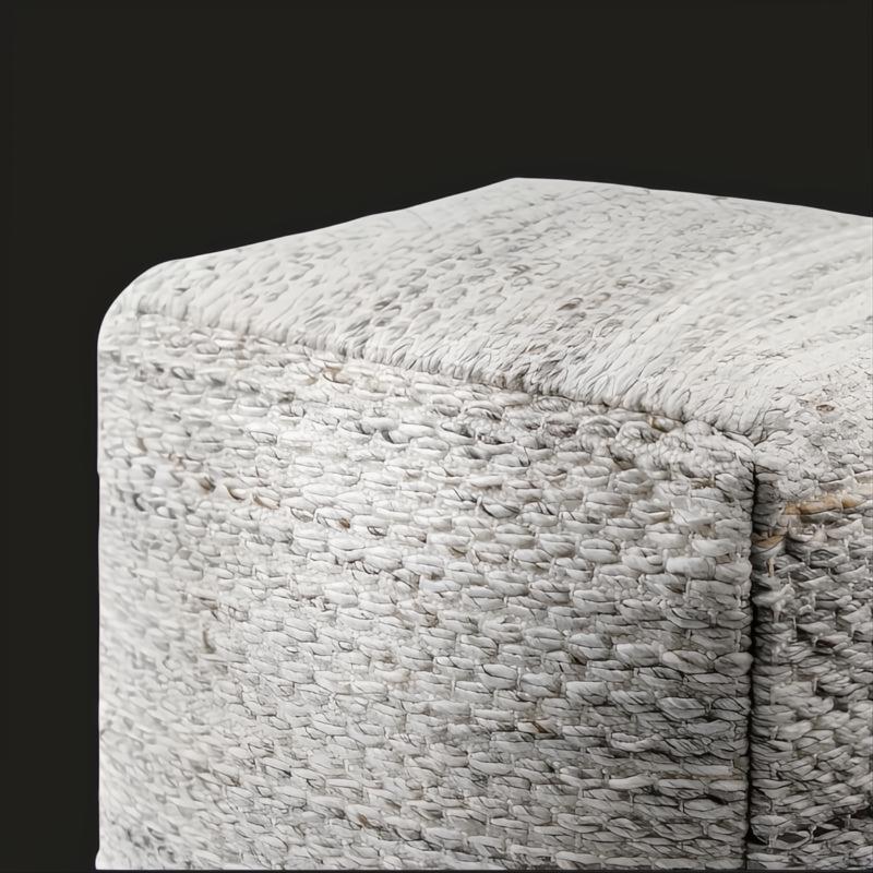 Modern woven light gray pouf made from recycled PET yarn with a textured cube shape and knife-edge finish.