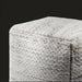 Modern woven light gray pouf made from recycled PET yarn with a textured cube shape and knife-edge finish.