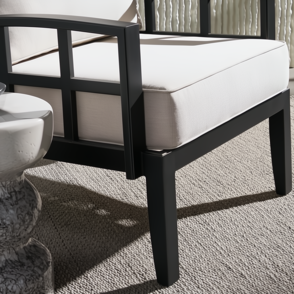 Surya Fairborn outdoor accent chair with black aluminum frame and light Sunbrella cushions.