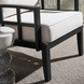 Surya Fairborn outdoor accent chair with black aluminum frame and light Sunbrella cushions.