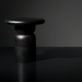 Surya Koben black mango wood end table with a compact round top and turned base.