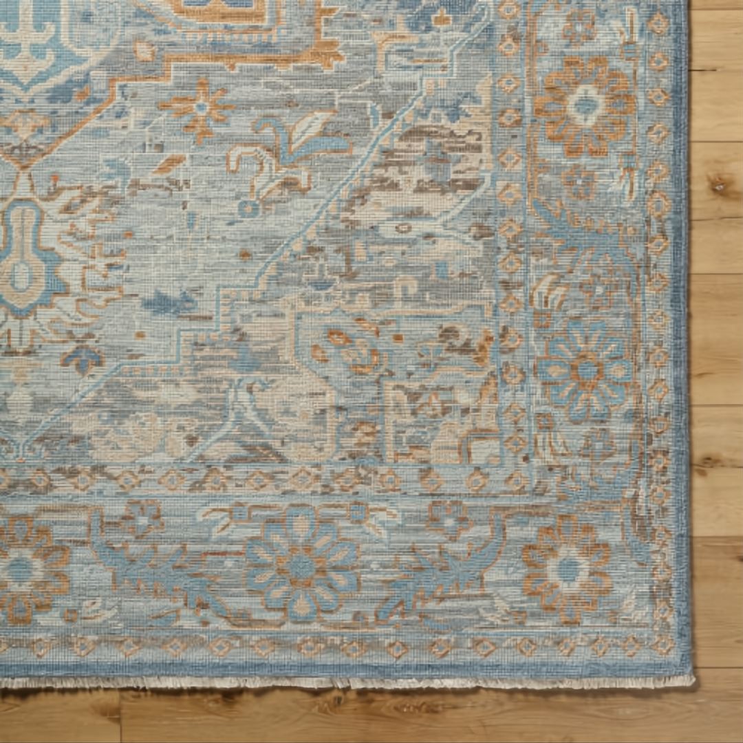 Surya Cappadocia hand-knotted wool rug with traditional pale blue, gray, taupe, and brown floral patterns.