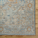 Surya Cappadocia hand-knotted wool rug with traditional pale blue, gray, taupe, and brown floral patterns.